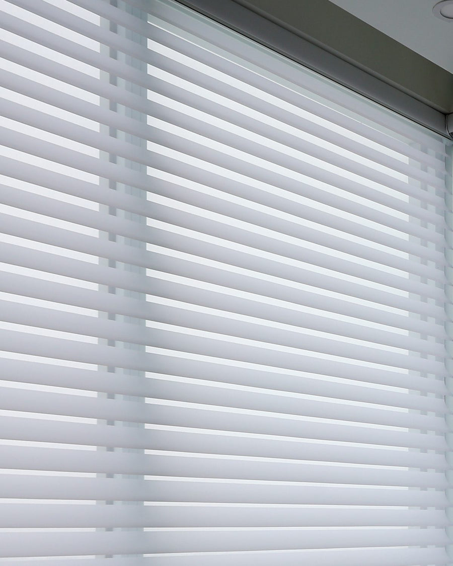 Two runs of shades meeting at a corner window, the lines matching across both